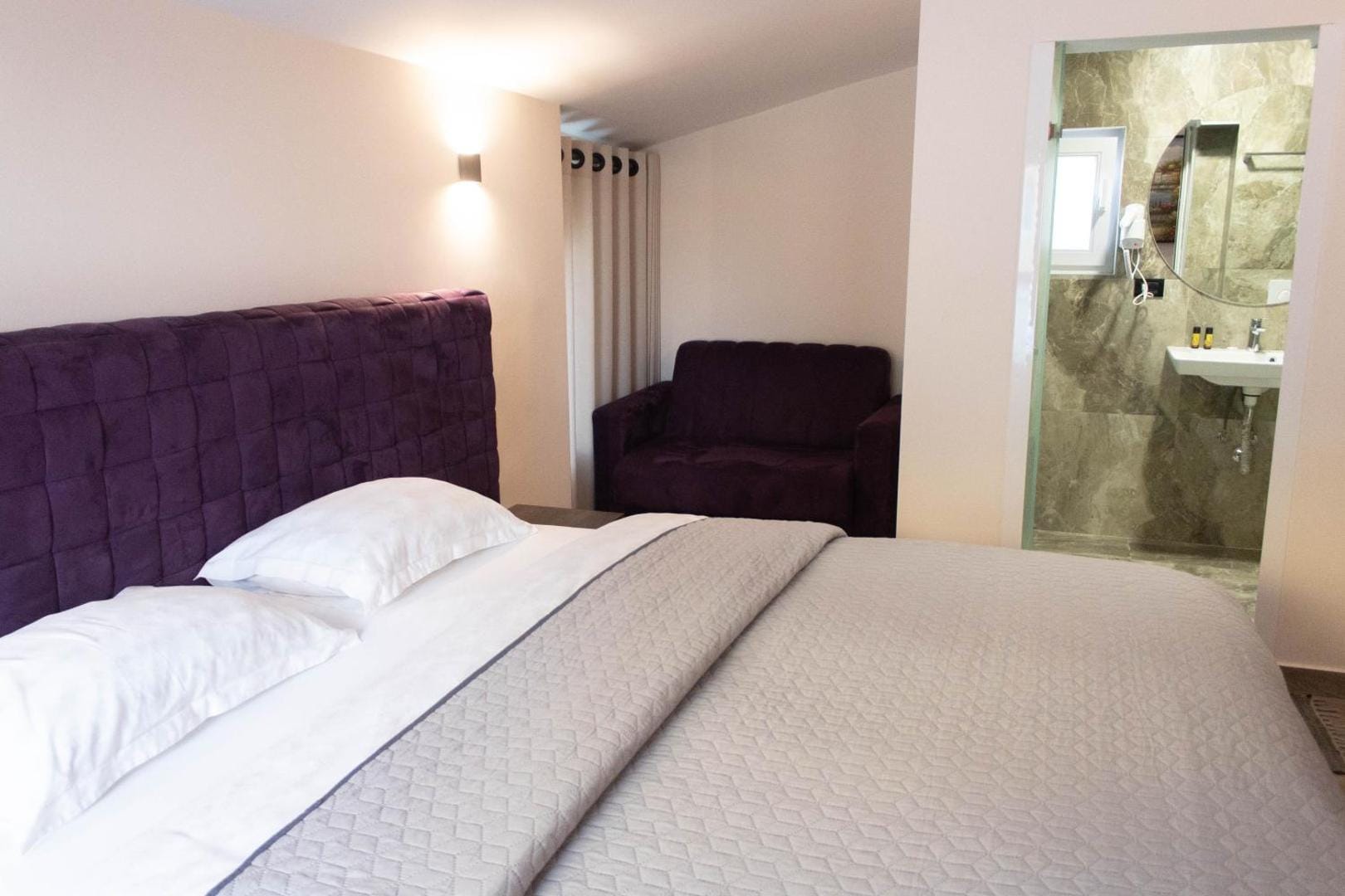 Second bed with a purple headboard