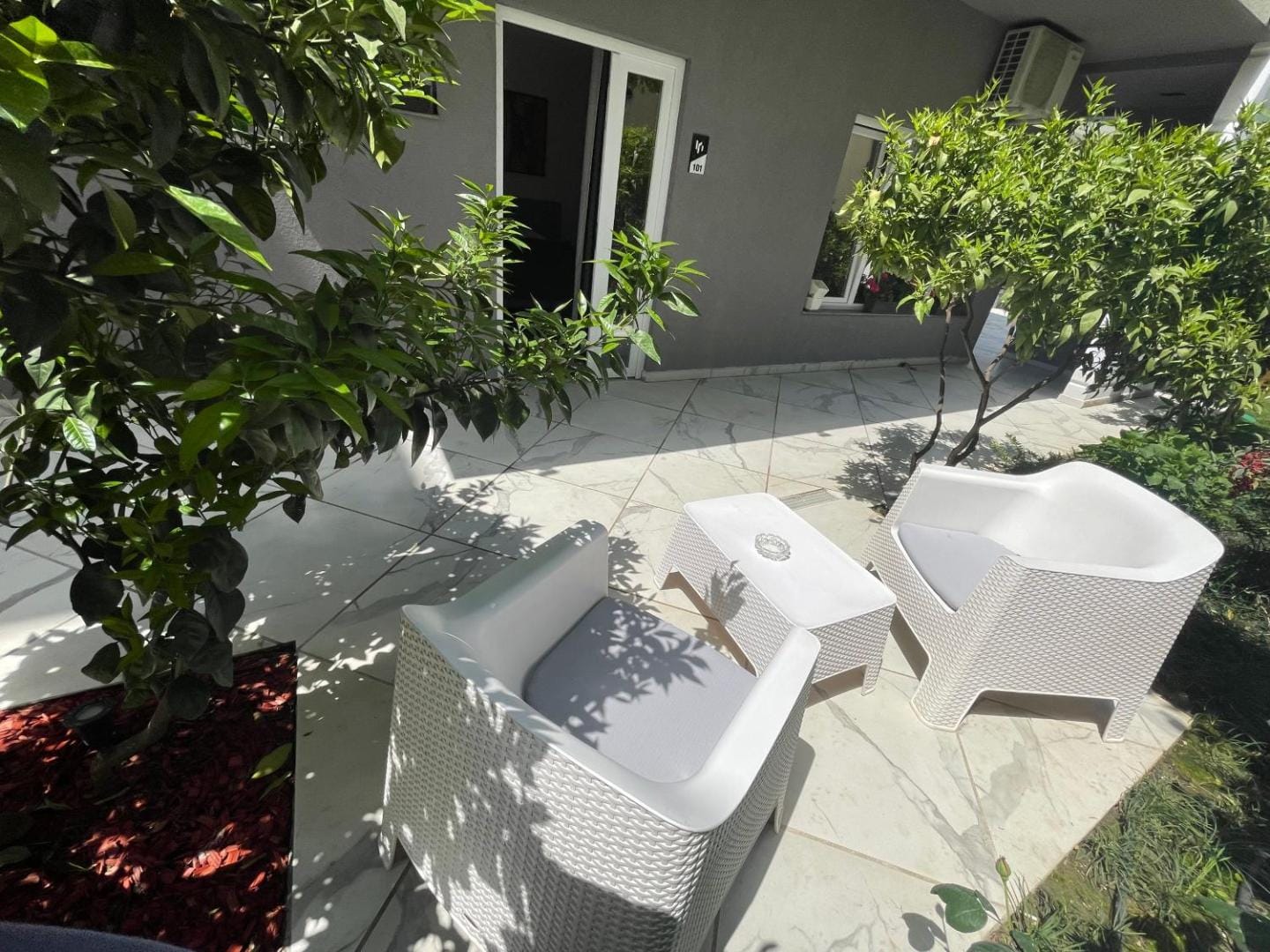 White armchairs under the trees