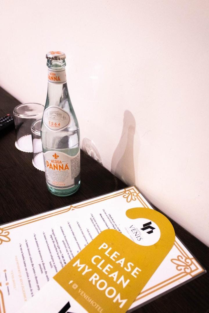A bottle and a glass on the tray