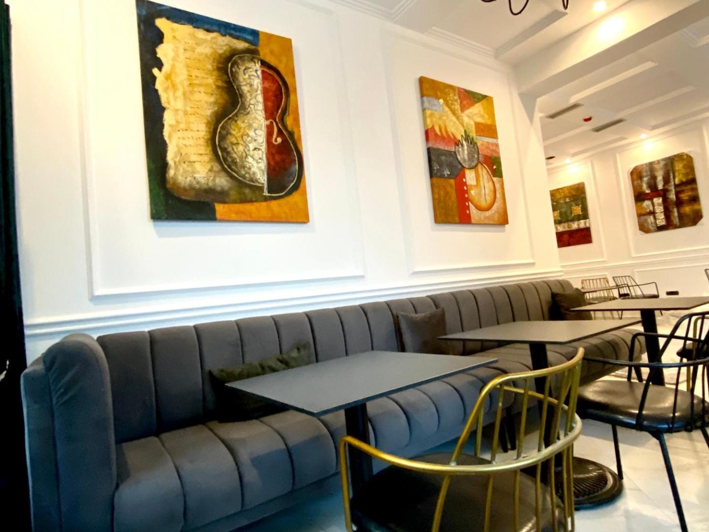 The blue banquette and brass chairs