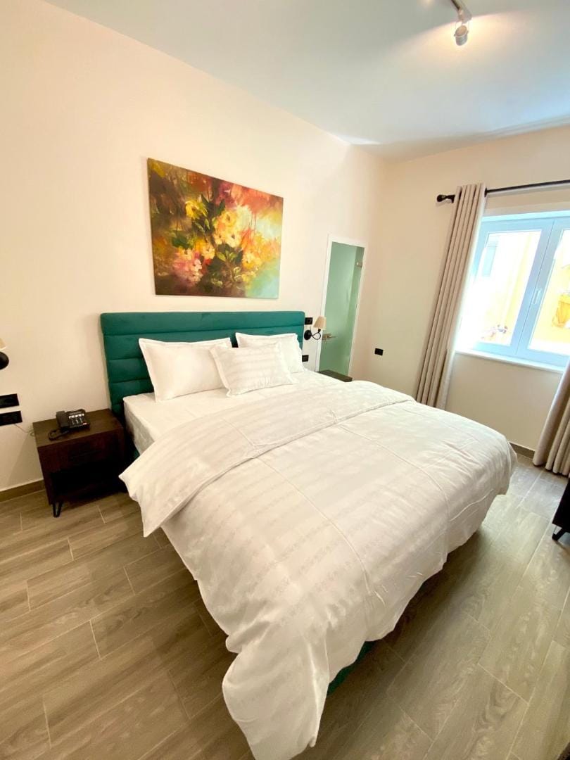 White bed under a painting