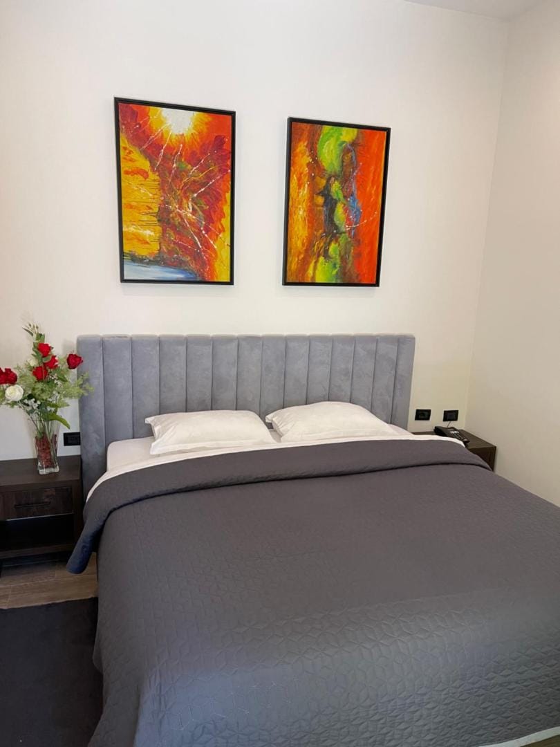 Bed with three paintings above it